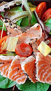 Delicious slices of scalded salmon with salad