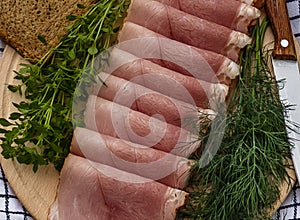 Delicious smoked ham on a wooden plate