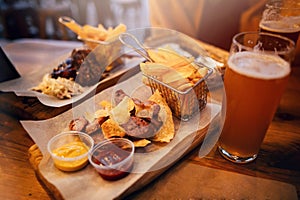 Delicious smoked sausage with chips, french fries and steak with