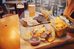 Delicious smoked sausage with chips, french fries and steak with