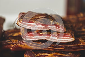 Delicious smoked unsliced  bacon  stand  at the meat market