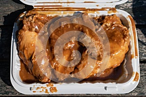 Delicious Smothered Chicken in a White Takeout Container