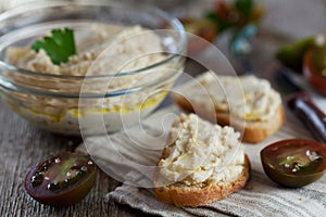 Delicious snack from crostini with chicken pate or paste and tomatoes