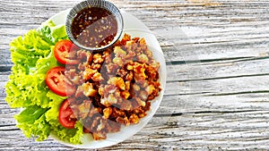 Delicious snack menu, fried chicken tendon served with green salad and sweet chilli sauce.