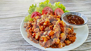 Delicious snack menu, fried chicken tendon served with green salad and sweet chilli sauce.