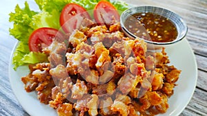 Delicious snack menu, fried chicken tendon served with green salad and sweet chilli sauce.