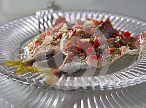 A delicious snack of pickled Mediterranean horse mackerel  Trachurus with garlic and hot red pepper in Greece