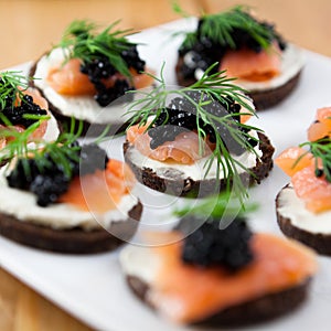 Delicious snack with salmon and caviar