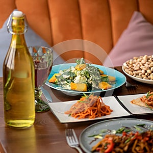 Delicious Snacks or appetizer food background, served dishes in restaurant. Spicy carrot, salad with basil and