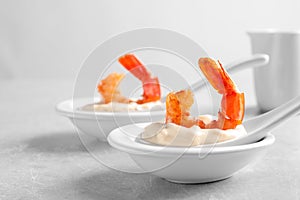 Delicious snacks with shrimp in spoons