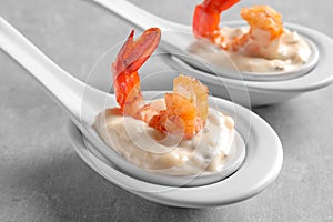 Delicious snacks with shrimp in spoons
