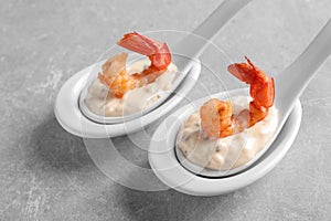 Delicious snacks with shrimp in spoons