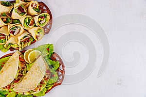 Delicious soft tortillas with salad and meat. Mexican cuisine