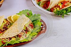 Delicious soft tortillas with salad and meat. Mexican cuisine