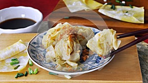 Delicious Soft Wanton on Chopsticks with Dipping Sauce on Background