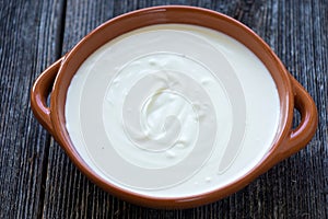 Delicious sour milk in a clay bowl