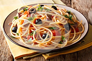 Delicious spaghetti alla putanesca with anchovies with vegetable