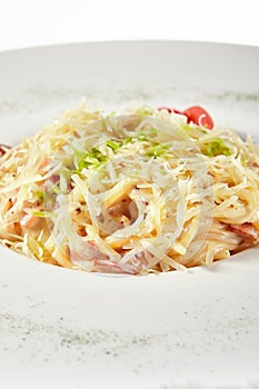 Delicious spaghetti carbonara with grated parmesan cheese