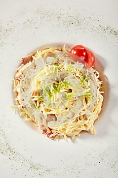 Delicious spaghetti carbonara with grated parmesan cheese