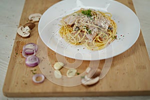 Delicious spaghetti carbonara served with shallow depth of field