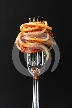 Delicious Spaghetti Pasta Twirled on Fork Against Dark Background photo