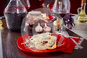 Delicious spaghetti served on a red plate