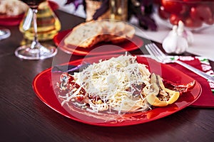 Delicious spaghetti served on a red plate