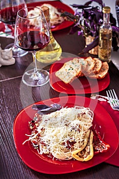 Delicious spaghetti served on a red plate