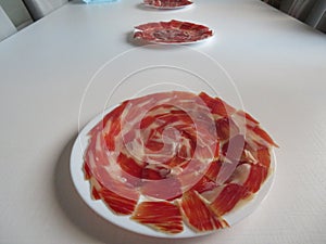 delicious Spanish Iberian ham cut with fantastic aromatic tasty knife photo