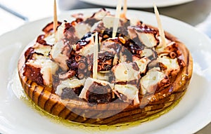 Delicious Spanish octopus on wooden plate pulpo a la gallega. photo