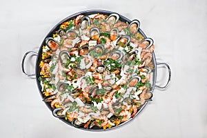 Delicious spanish paella rice with prawn, mussels, squids in pan