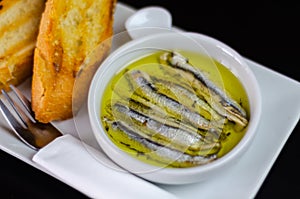 delicious Spanish snack, fresh fish marinated in olive oil, served with croutons