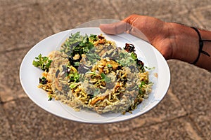 Delicious spicy chicken biryani in white bowl on white background, Indian food. Chicken Dum Biryani