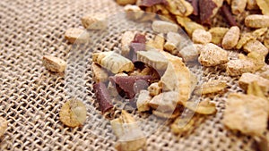 Delicious sprinkle of chocolate shavings and cookies on a rustic rough burlap. Macro