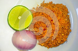 Delicious Sri Lankan coconut sambol & x28;pol sambola& x29; decorated with lemon and onion