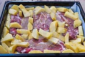 delicious steaks with baked potatoes, ready to go into the oven