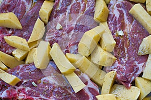 delicious steaks with baked potatoes, ready to go into the oven