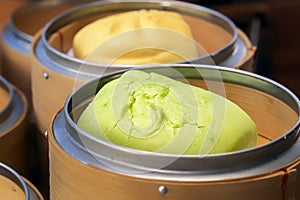 Delicious steamed buns in a bamboo double boiler - a traditional Asian street food.