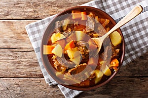 delicious stew estofado with beef and vegetables close-up. Horizontal top view photo