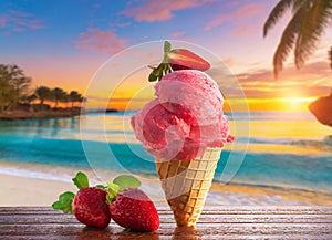 A delicious strawberry ice cream cone on a table on a tropical beach at sunrise or sunset.