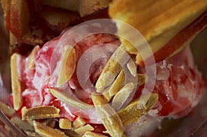 Delicious strawberry ice cream dessert with almond and waffle macro close up for food