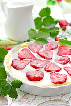 Delicious strawberry tart or cheesecake with fresh berries and cream cheese, closeup