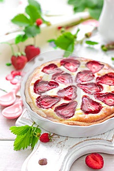 Delicious strawberry tart or cheesecake with fresh berries and cream cheese, closeup