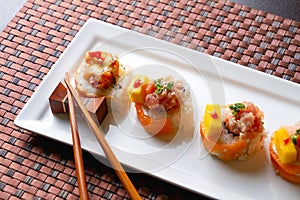 Delicious suchi mounted on an elongated glass plate. photo