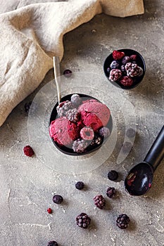 Delicious summer berries yogurt ice cream with berries on grey background, frozen berries, vegetarian and vegan ice cream