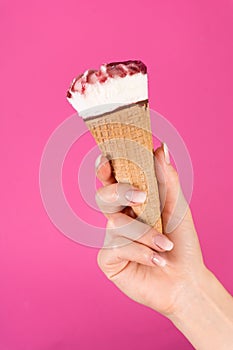 Delicious Summer Delight: Sweet Ice Cream Cone in Young Girl\'s Hand