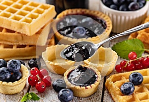 Delicious summer snacks - blueberry jam, tarte and waffle sweets