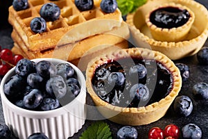 Delicious summer snacks - blueberry jam, tarte and waffle sweets