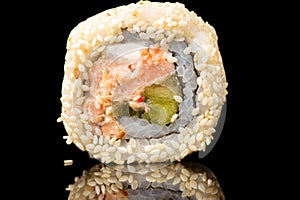 Delicious sushi roll with sesame closeup
