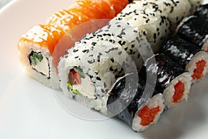 Delicious sushi rolls on white bowl background. Japanese food